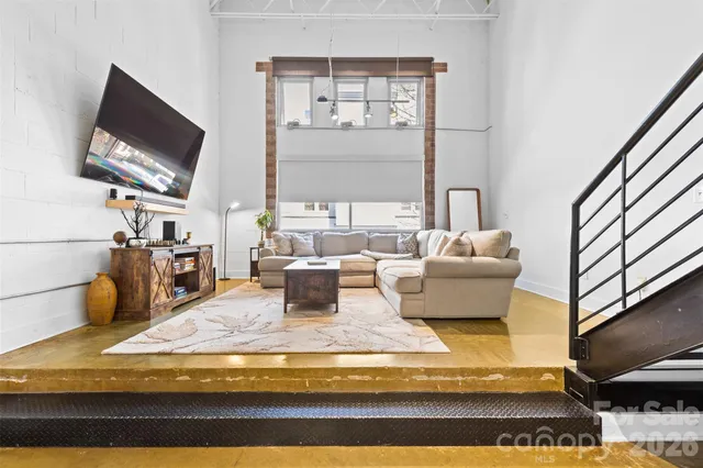 a living room with fireplace furniture and a flat screen tv