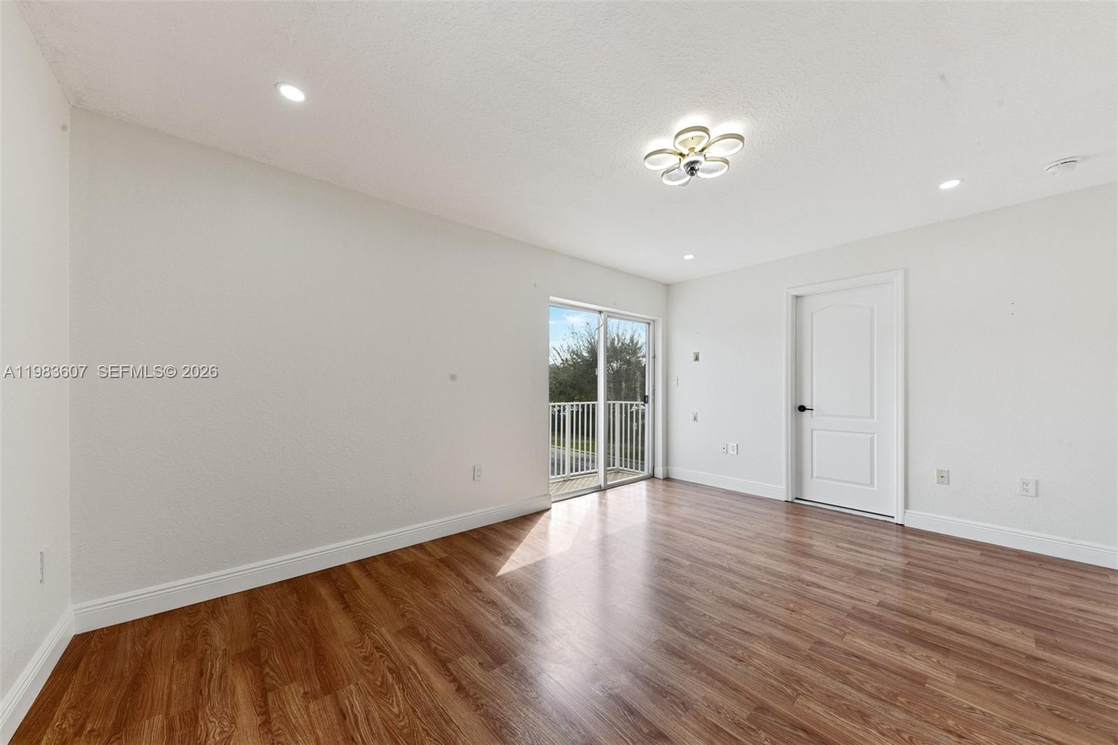 2897 Southwest 129th Way Miramar, FL 33027 - Photo 11 of 22 a view of an empty room with wooden floor and a window