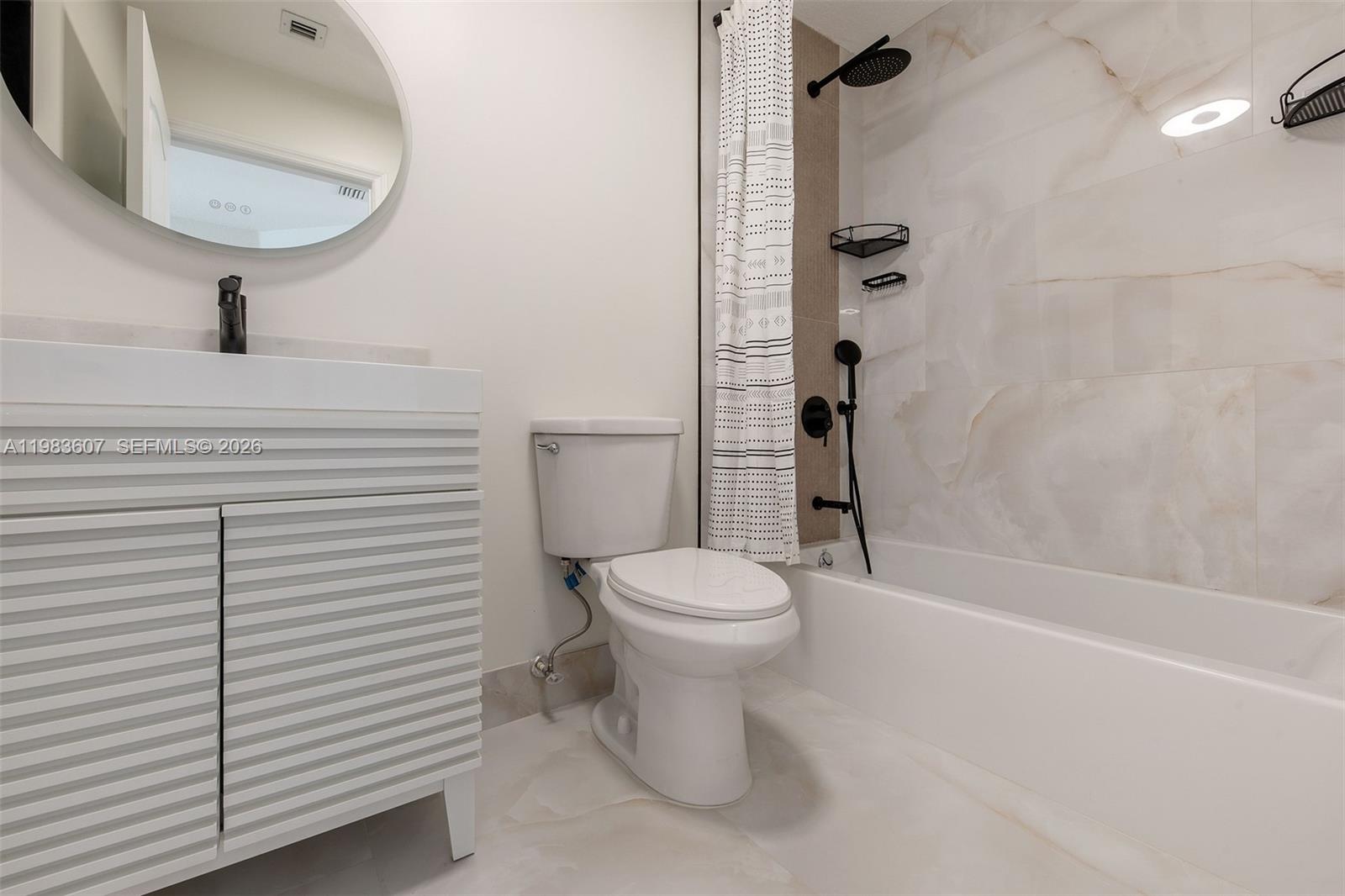 2897 Southwest 129th Way Miramar, FL 33027 - Photo 14 of 22 a bathroom with a toilet a sink and garden