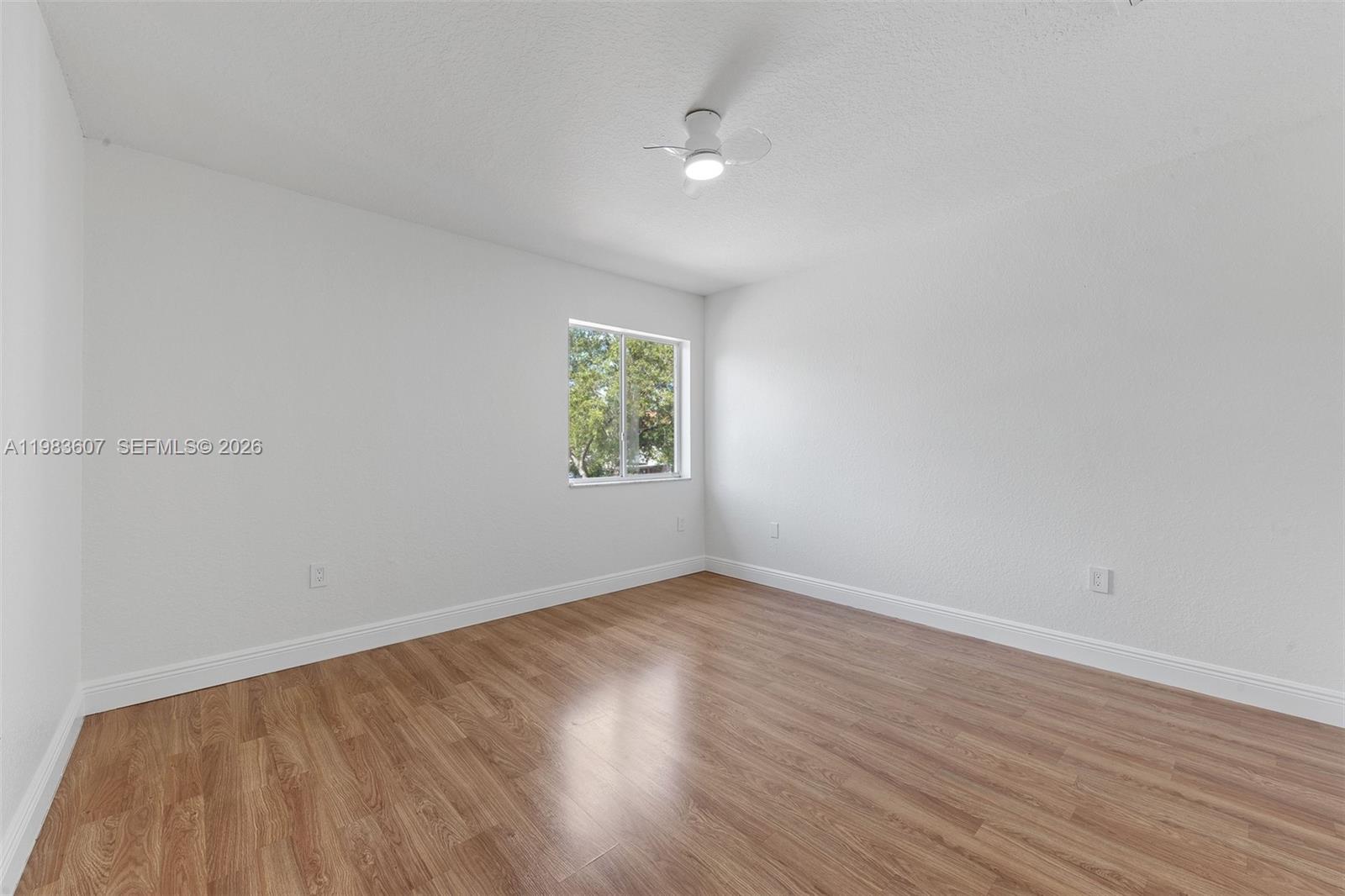 2897 Southwest 129th Way Miramar, FL 33027 - Photo 15 of 22 an empty room with wooden floor and windows