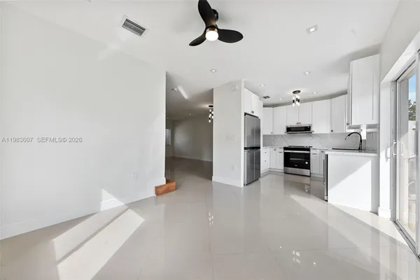 a large kitchen with cabinets and stainless steel appliances