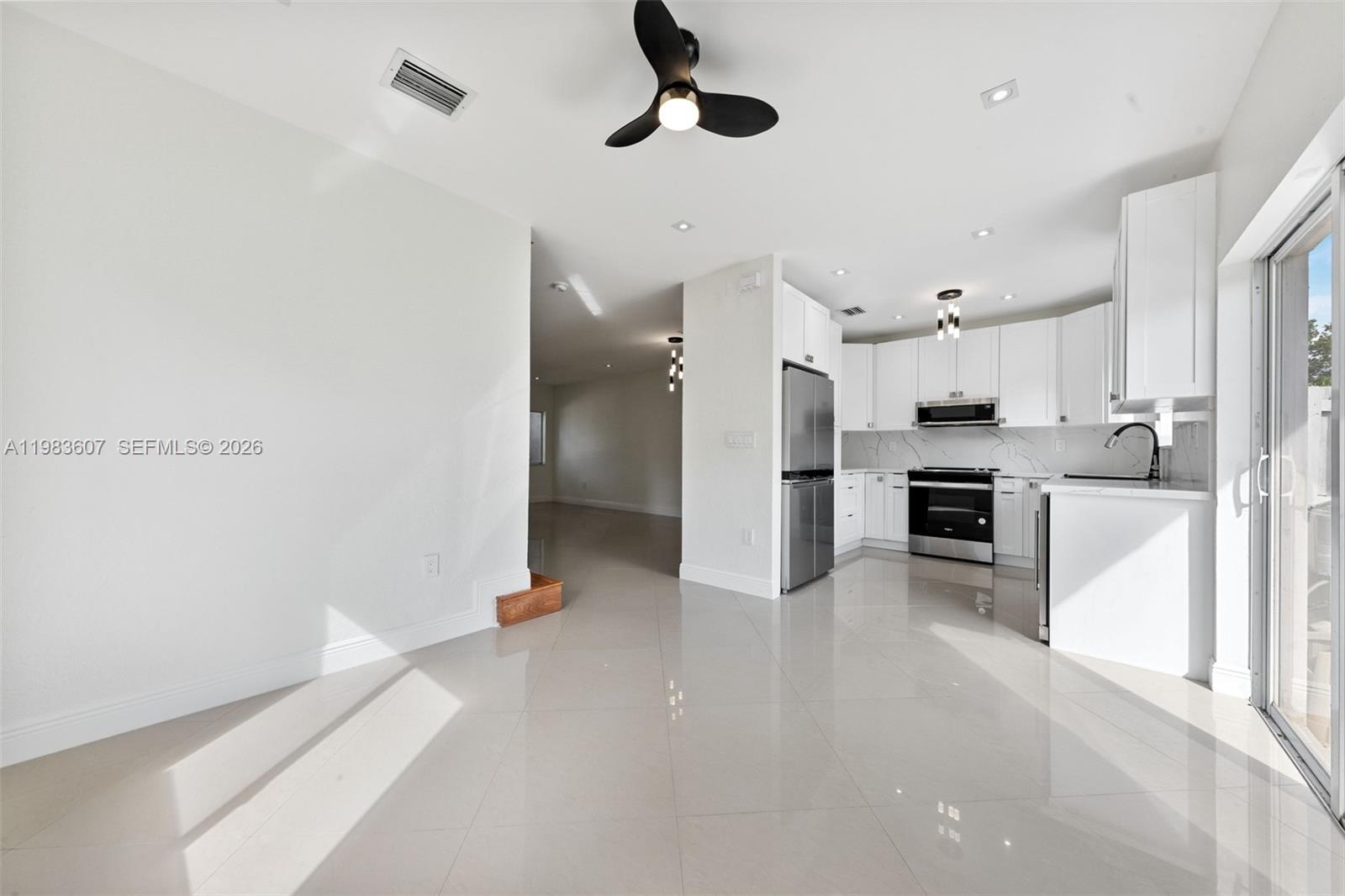 2897 Southwest 129th Way Miramar, FL 33027 - Photo 6 of 22 a large kitchen with cabinets and stainless steel appliances