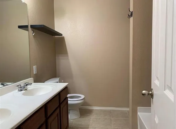 a bathroom with a sink toilet and vanity
