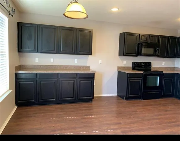 a kitchen with stainless steel appliances wooden cabinets and a sink