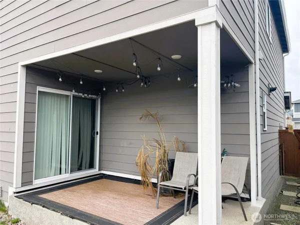 a view of a house with a patio and backyard