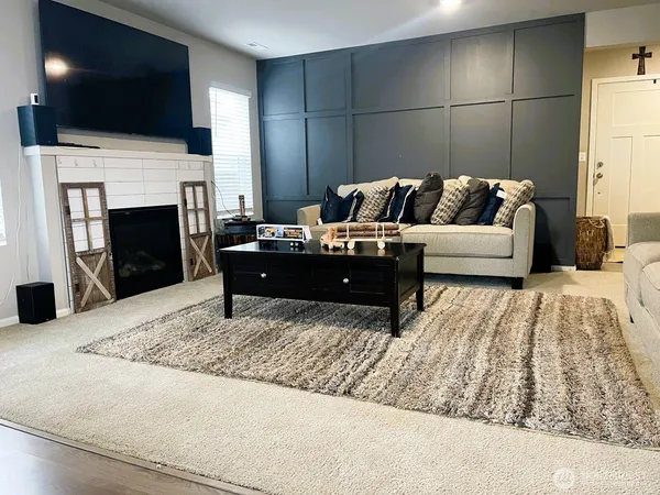 a living room with furniture and a fireplace