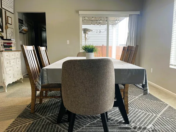 a view of a dining room with furniture and window