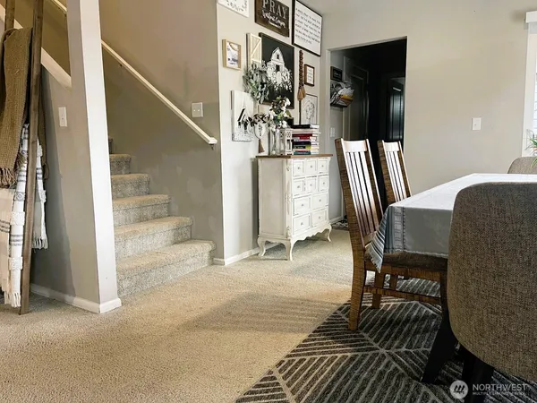 a view of a hallway with furniture and floor to ceiling window