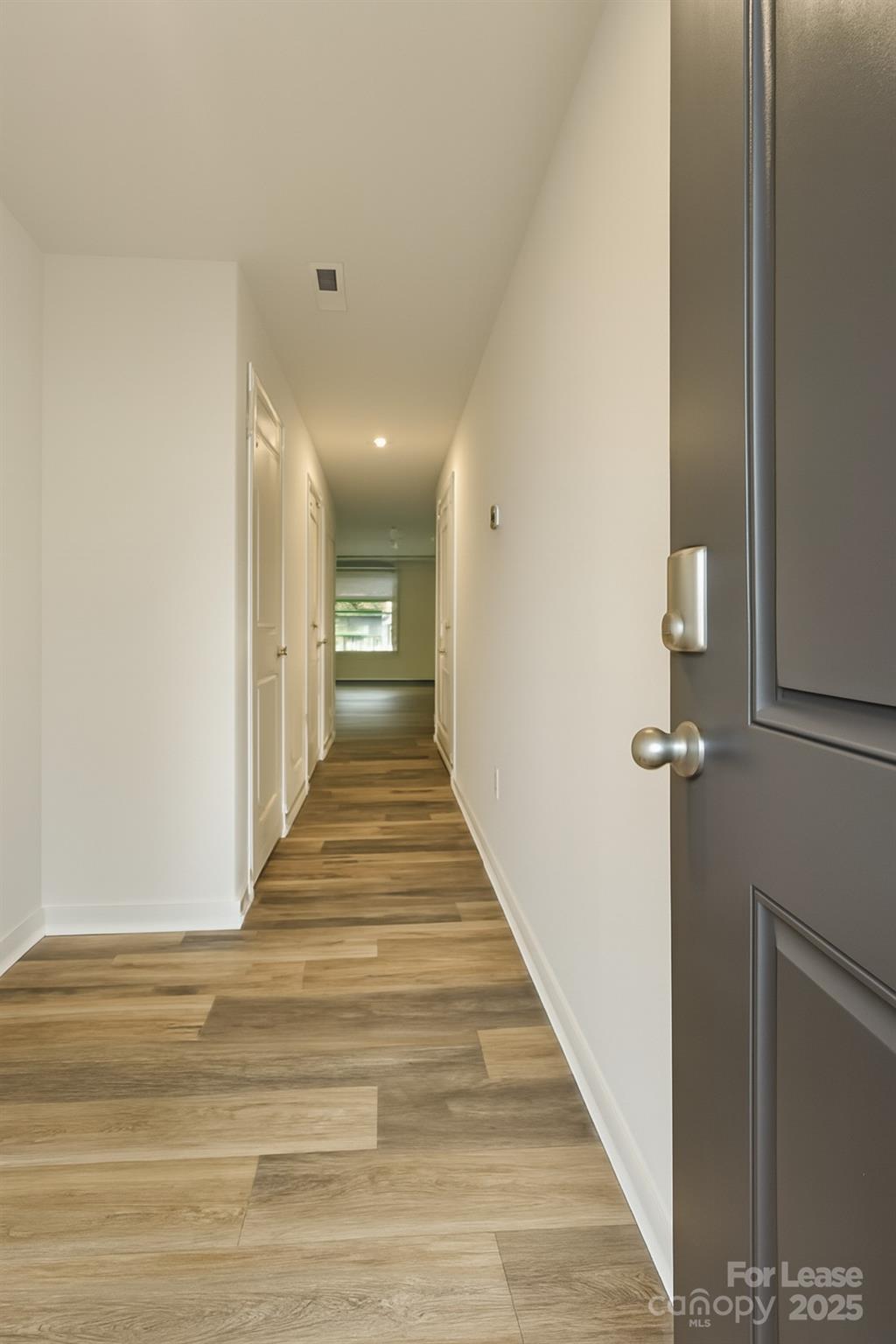 6104 Faron Way Charlotte, NC 28262 - Photo 3 of 17 a view of a hallway with wooden floor and staircase
