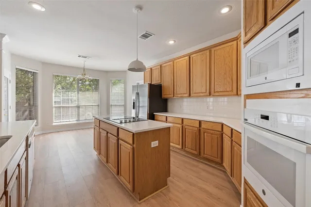 a kitchen with stainless steel appliances granite countertop a stove and a sink