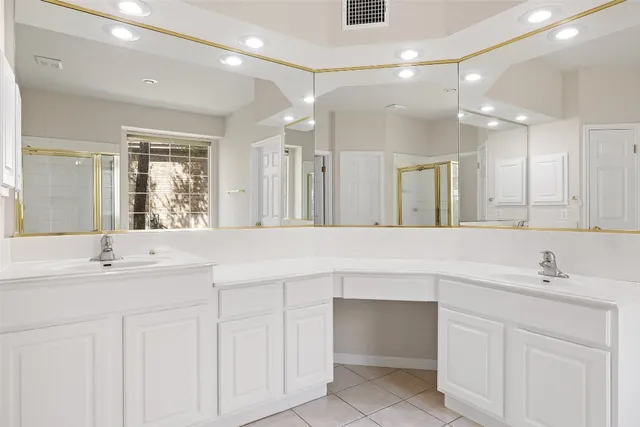a bathroom with a sink double vanity and a mirror