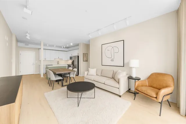 a living room with furniture a rug and a lamp