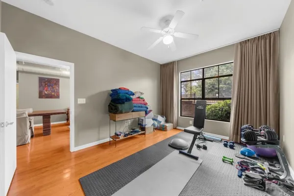 a view of a livingroom with workspace and a window