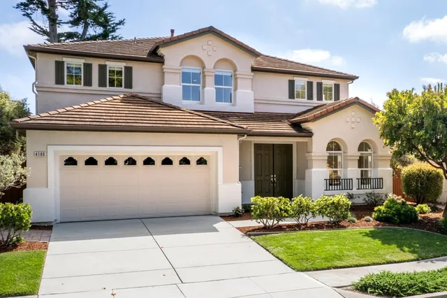 a view of white house with garden