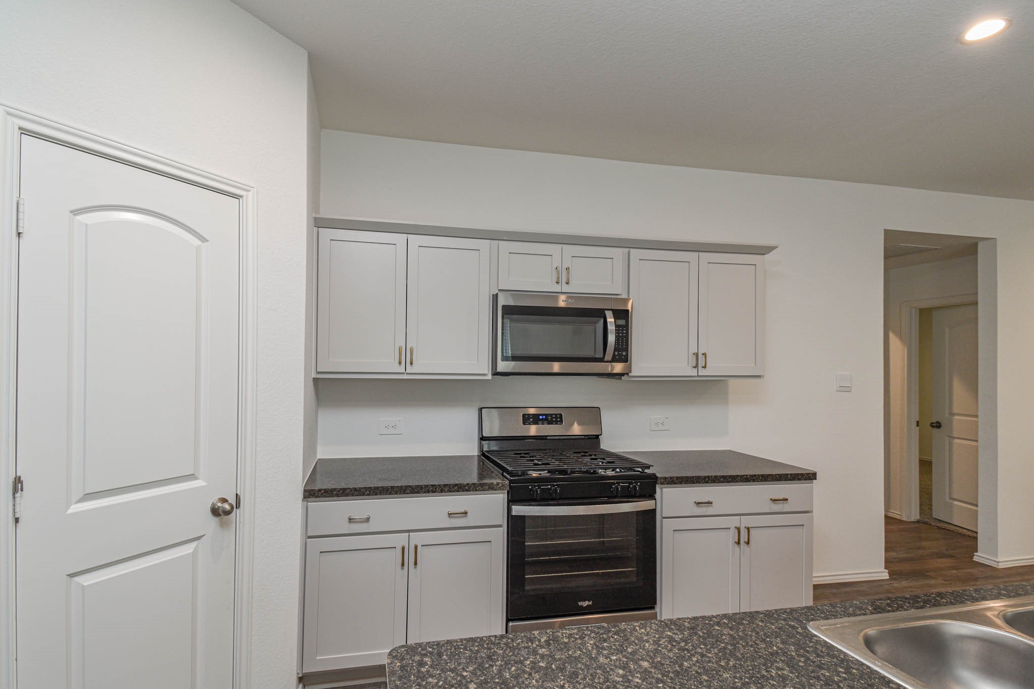 5423 Wyndham Ridge Ln Spring Spring, TX 77373 - Photo 13 of 23 a kitchen with stainless steel appliances granite countertop white cabinets and stove top oven