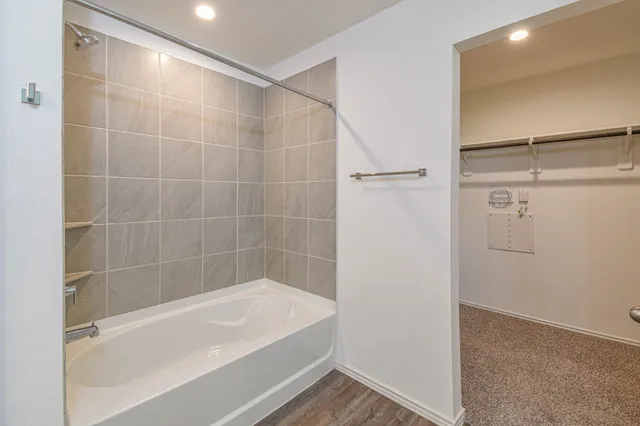 a bathroom with a bathtub and a shower