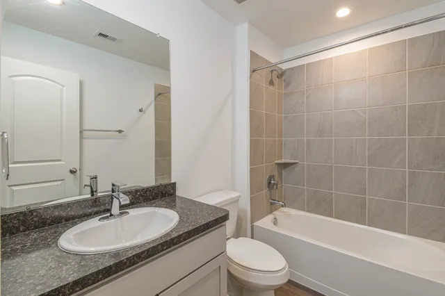 a bathroom with a sink a toilet and a bathtub