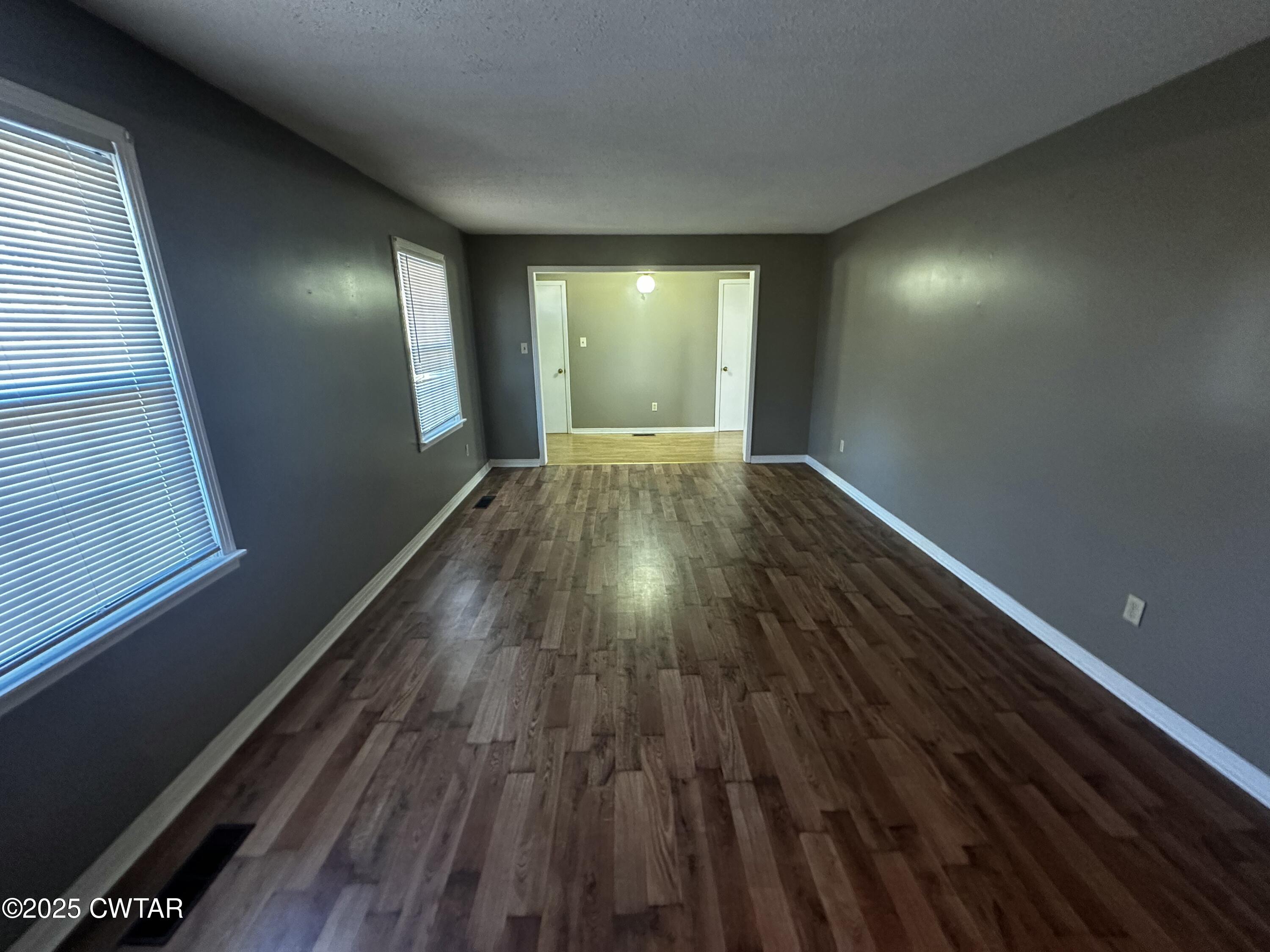 1705 Highway 100 Decaturville, TN 38329 - Photo 14 of 45 a view of an empty room with wooden floor and a window