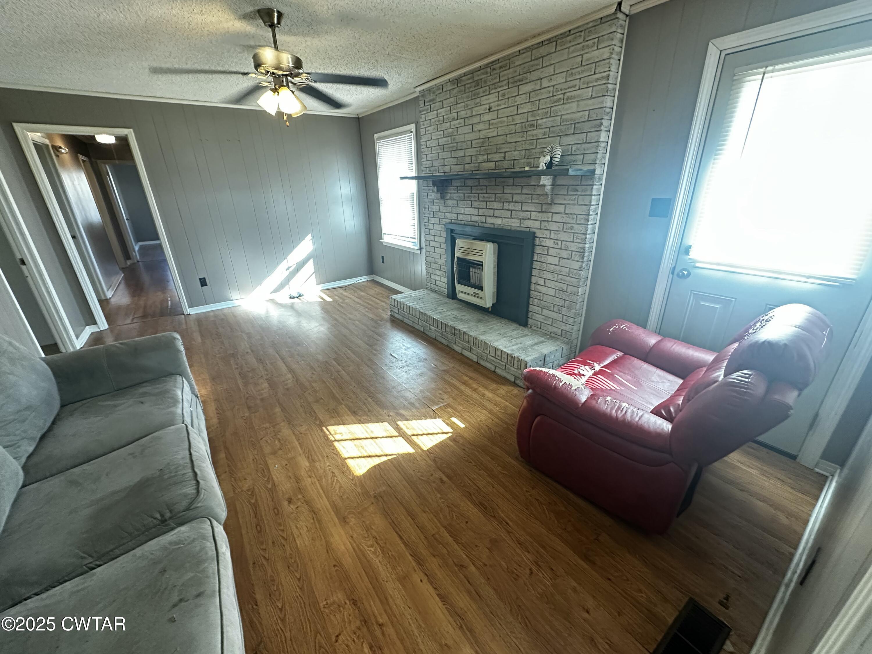 1705 Highway 100 Decaturville, TN 38329 - Photo 16 of 45 a living room with furniture and a fireplace