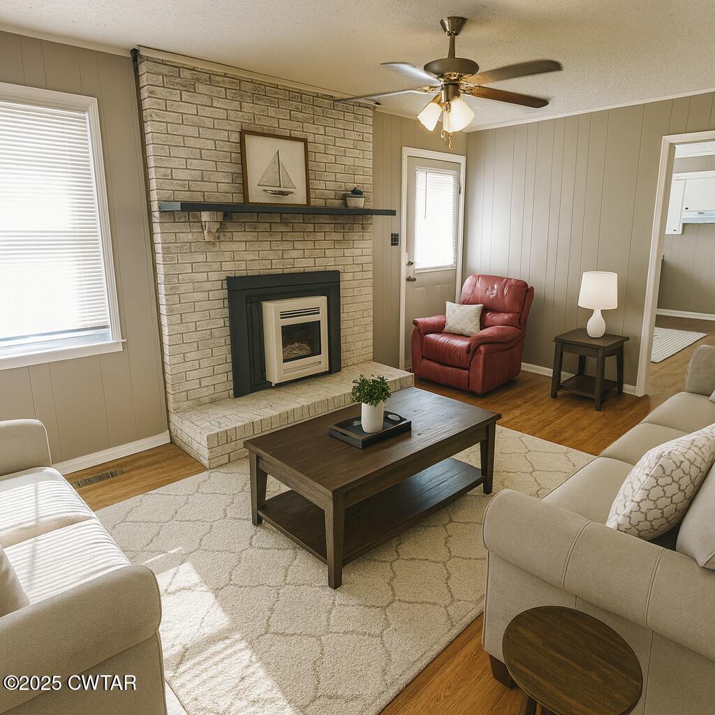 1705 Highway 100 Decaturville, TN 38329 - Photo 19 of 45 a living room with furniture a flat screen tv and a fireplace