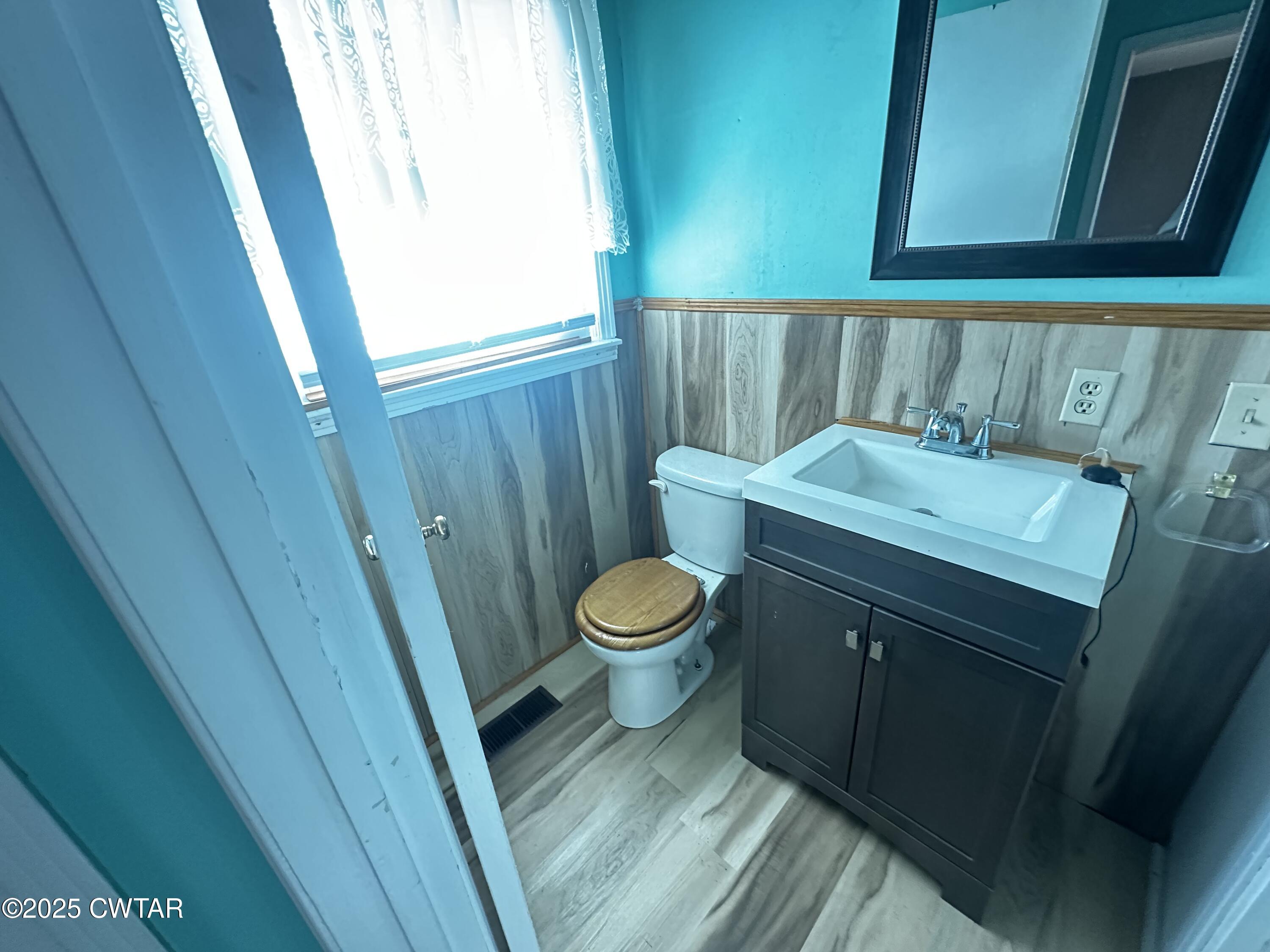 1705 Highway 100 Decaturville, TN 38329 - Photo 30 of 45 a bathroom with a toilet a sink and a window