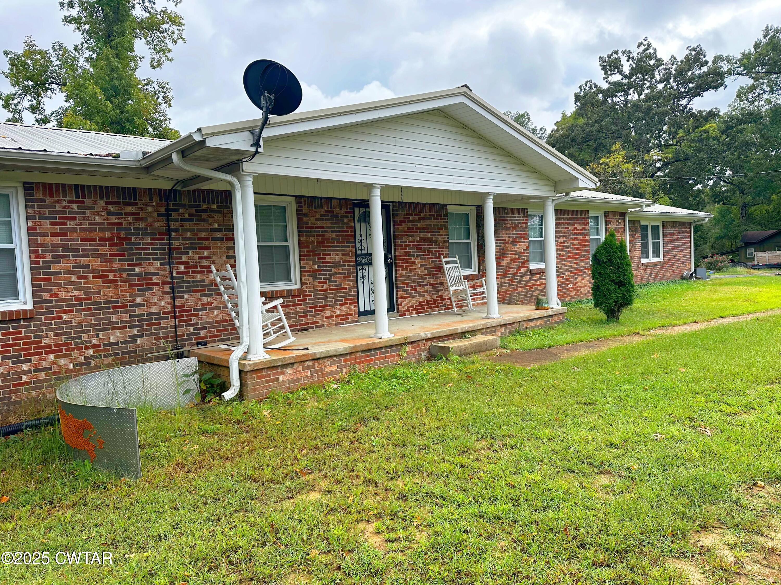1705 Highway 100 Decaturville, TN 38329 - Photo 3 of 45 front view of a house with a yard