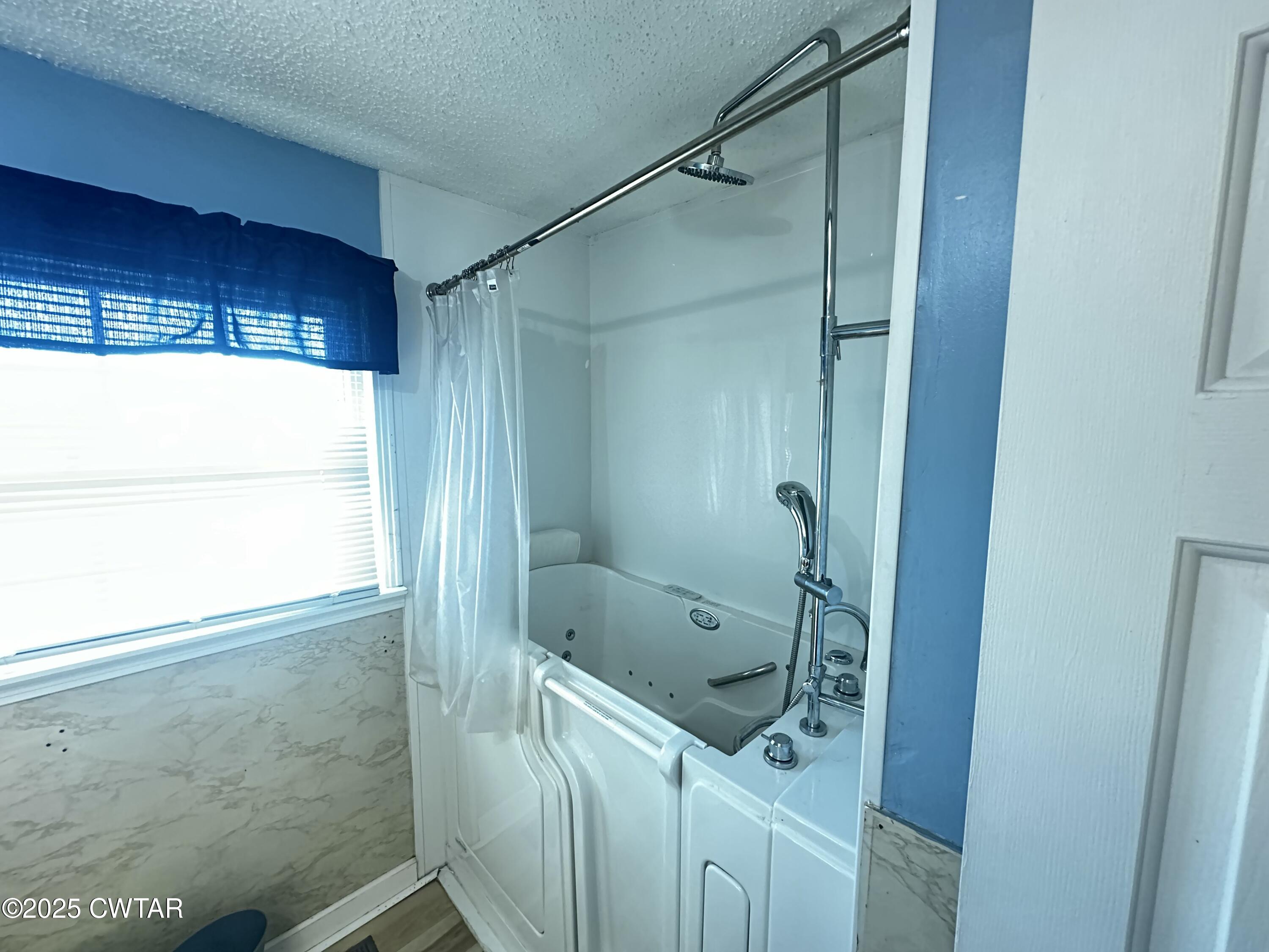 1705 Highway 100 Decaturville, TN 38329 - Photo 33 of 45 a bathroom with a shower and a sink