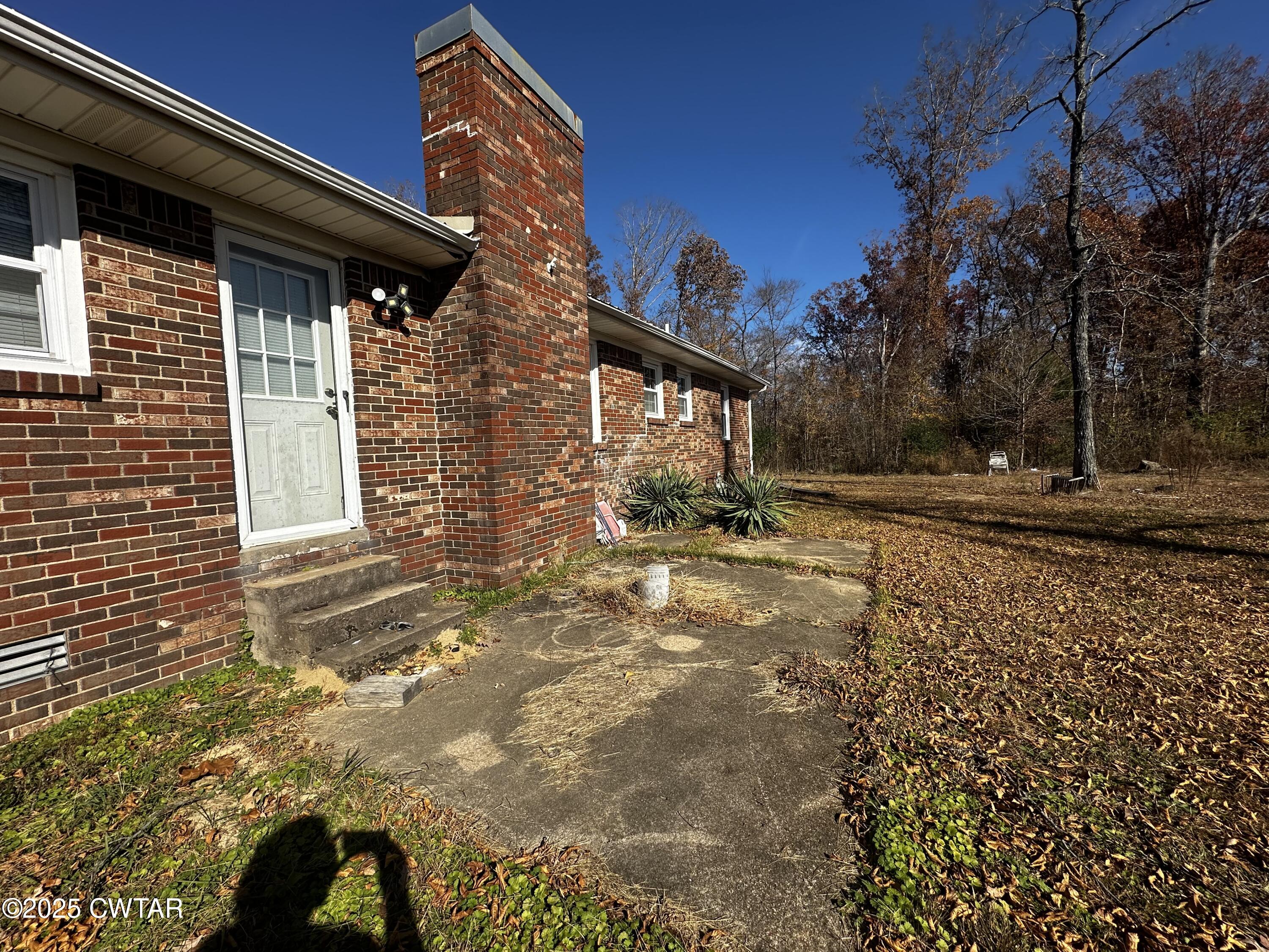 1705 Highway 100 Decaturville, TN 38329 - Photo 36 of 45 a view of a house with a yard
