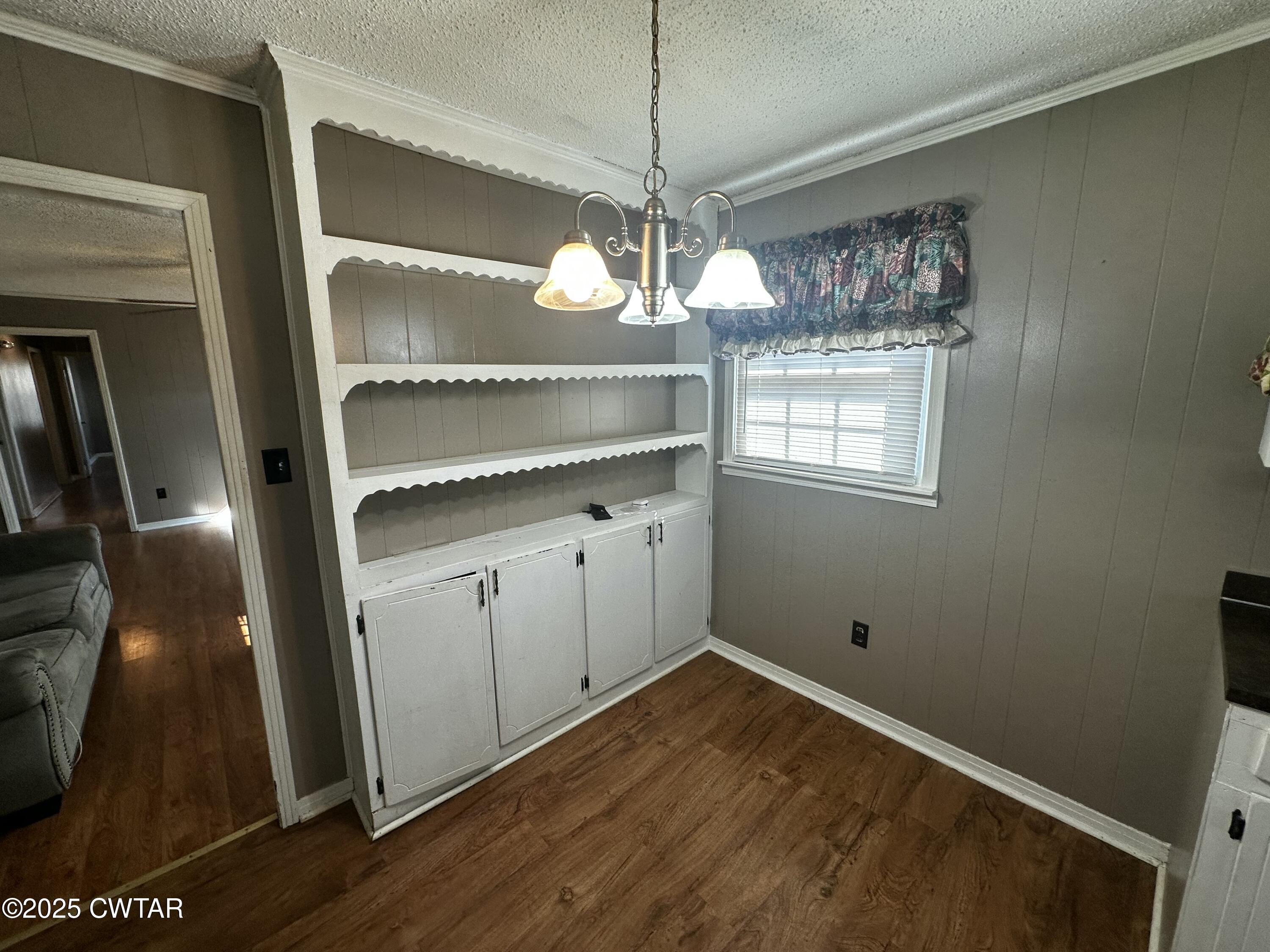 1705 Highway 100 Decaturville, TN 38329 - Photo 7 of 45 a room with chandelier fan and wooden floor