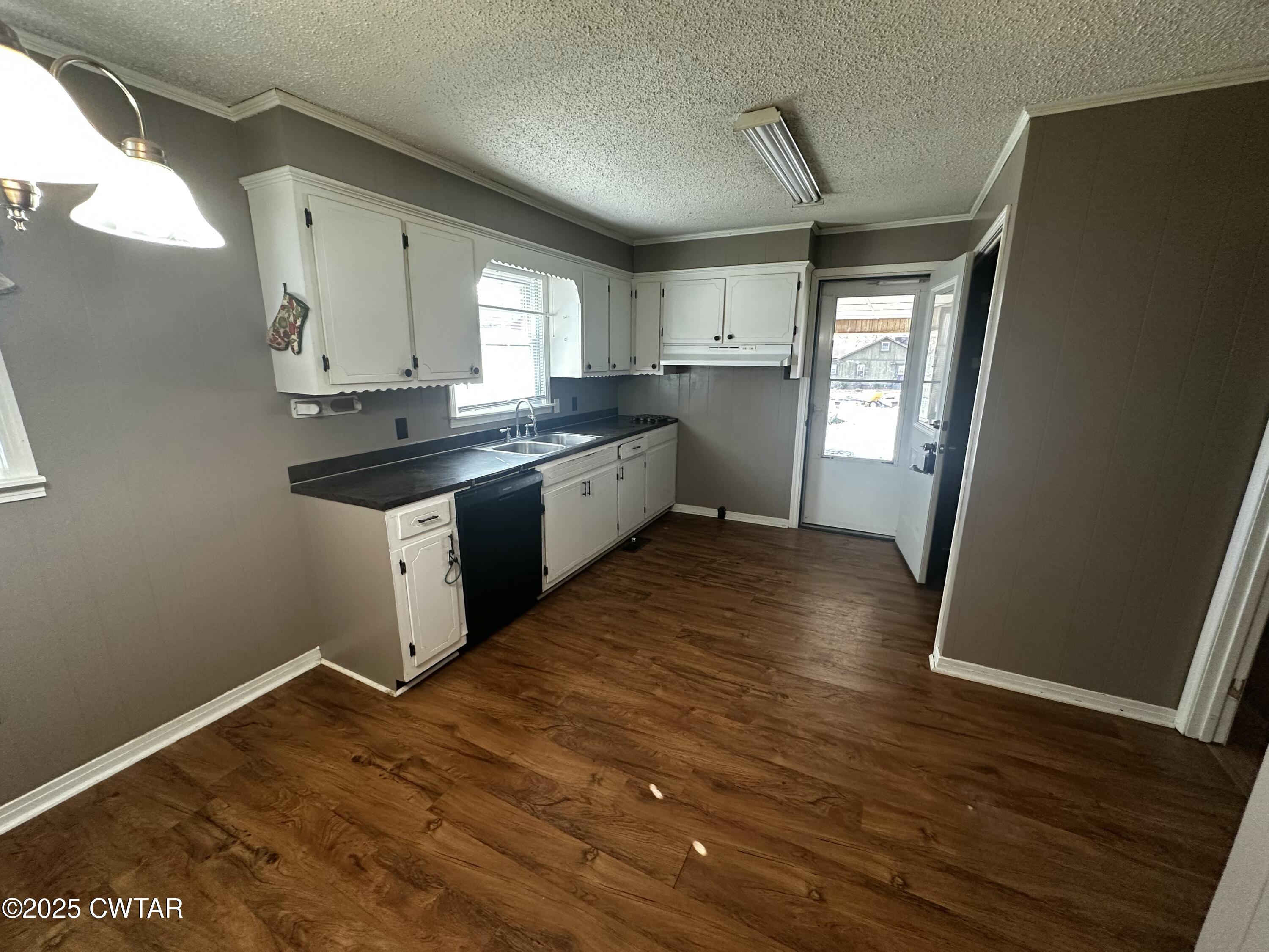 1705 Highway 100 Decaturville, TN 38329 - Photo 9 of 45 a kitchen with granite countertop a sink cabinets and wooden floor