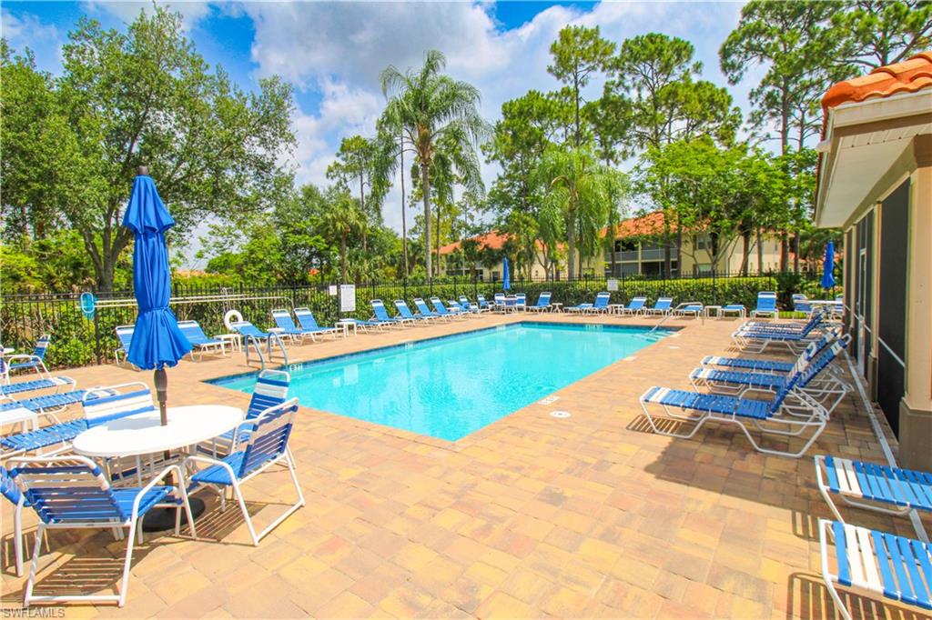 225 Robin Hood Circle, Unit 203 Naples, FL 34104 - Photo 49 of 50 View of pool with a patio area