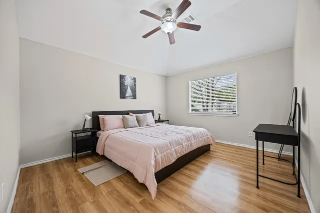 a bedroom with a bed a table and chair