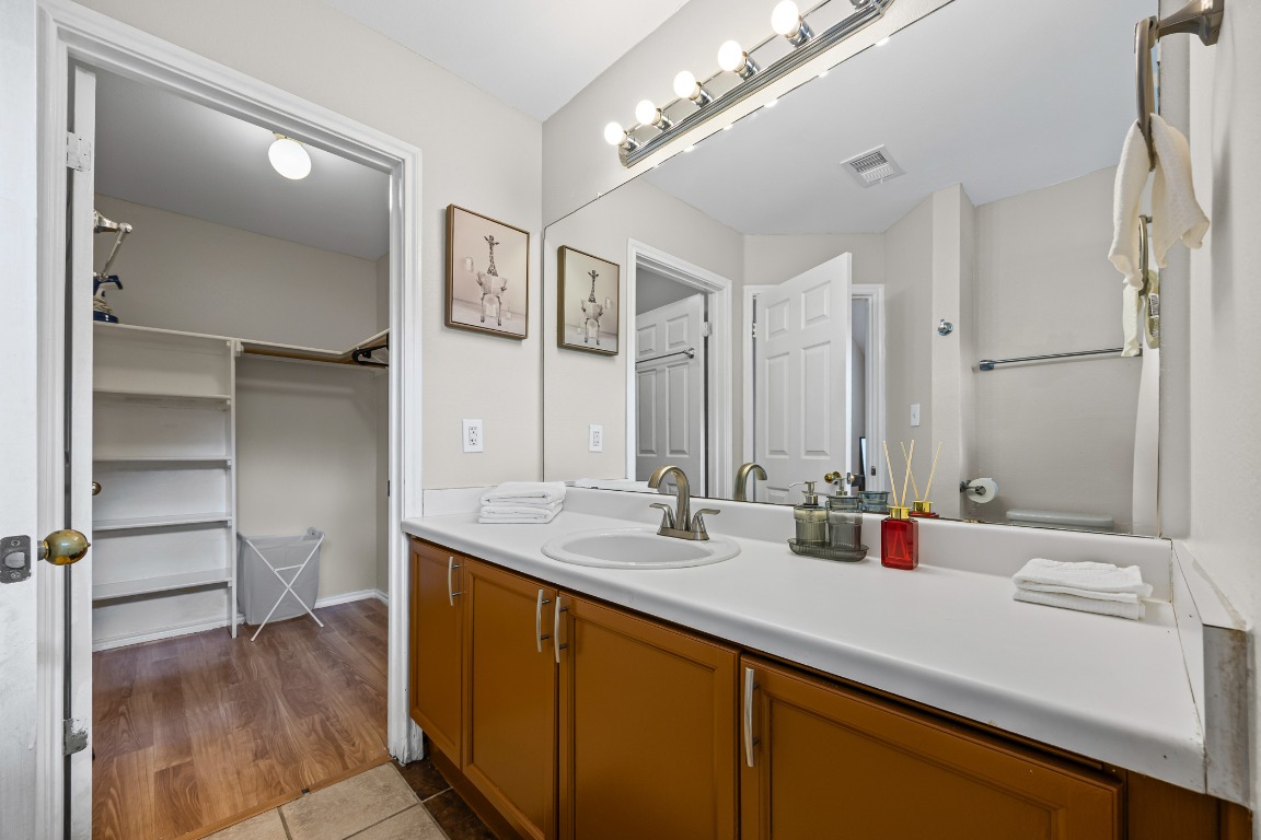 5006 Acorn Grove Court Austin, TX 78744 - Photo 19 of 36 a bathroom with a sink and a mirror