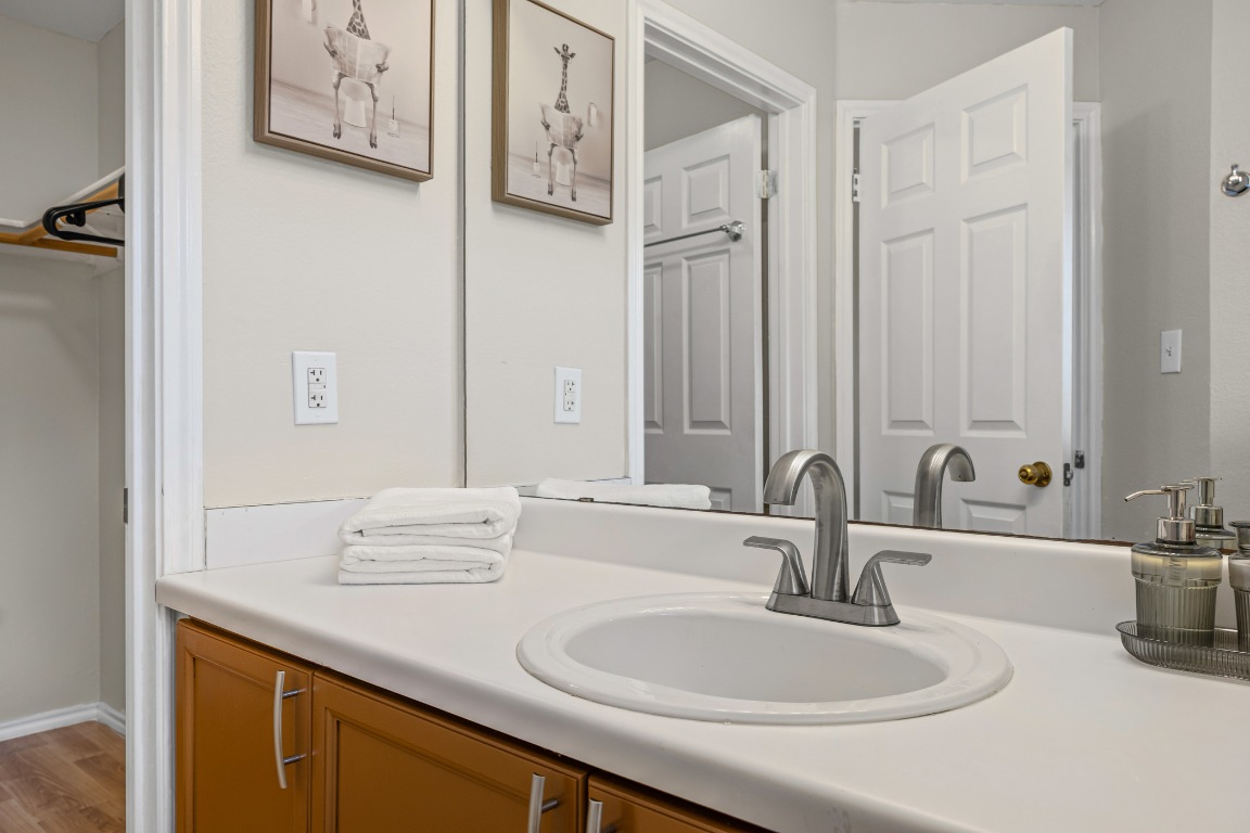 5006 Acorn Grove Court Austin, TX 78744 - Photo 20 of 36 a bathroom with a sink and a mirror