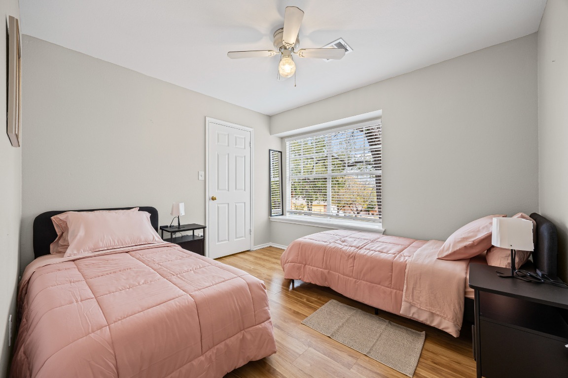 5006 Acorn Grove Court Austin, TX 78744 - Photo 21 of 36 a bedroom with a bed and a window