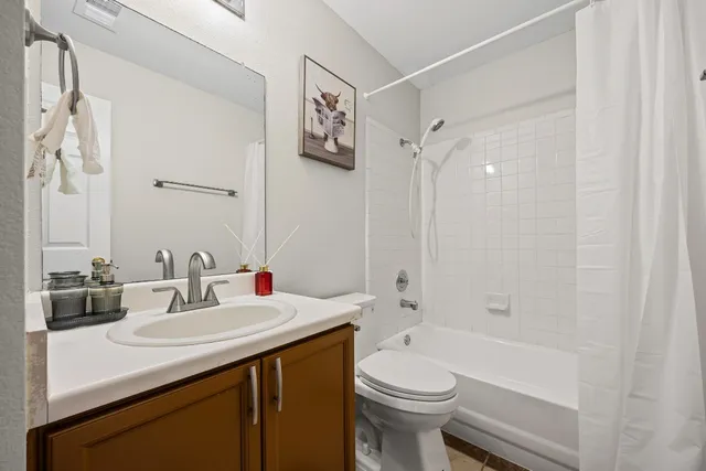 a bedroom with two beds and painting on the wall