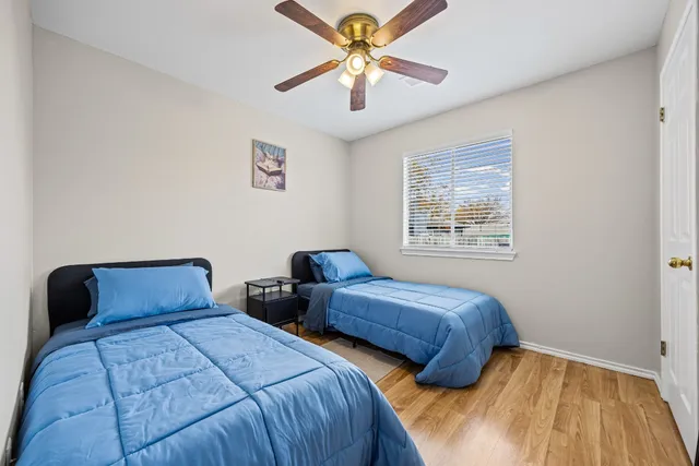 a bedroom with two beds and a chandelier