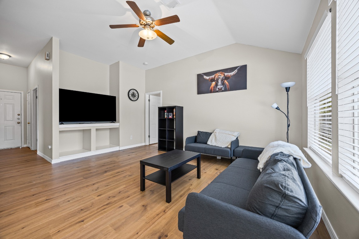 5006 Acorn Grove Court Austin, TX 78744 - Photo 5 of 36 a living room with furniture and a flat screen tv