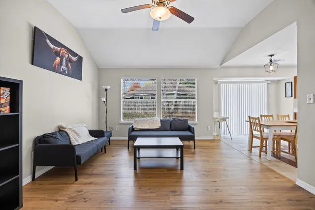 a living room with furniture and wooden floor