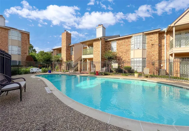 a swimming pool with outdoor seating and yard