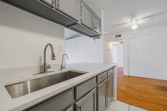 a kitchen with a sink and a refrigerator