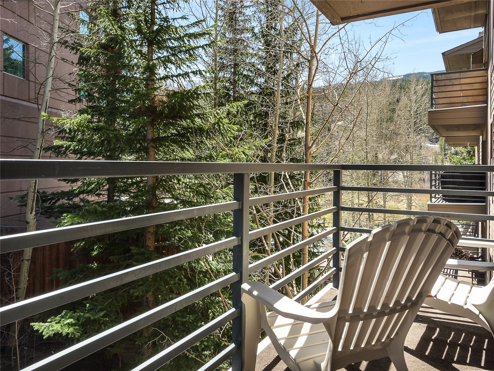 23034 Highway 6, Unit 305 Keystone, CO 80435 - Photo 15 of 27 a view of a balcony with wooden floor and fence