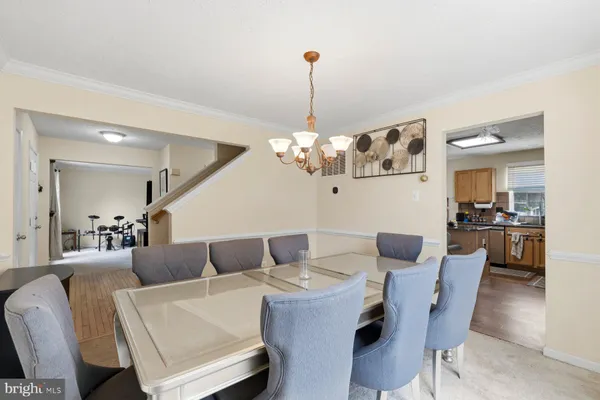 a dining room with furniture and chandelier