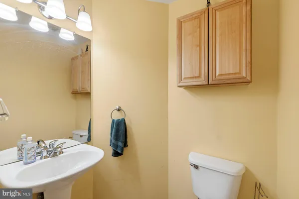 a bathroom with a sink a toilet and mirror