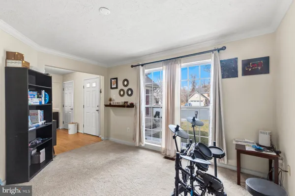 a view of a livingroom with furniture and a bookshelf