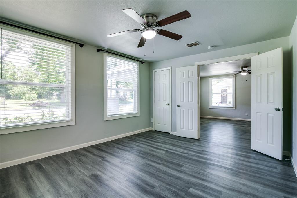 606 West High Street Terrell, TX 75160 - Photo 16 of 28 a view of an empty room with window and wooden floor
