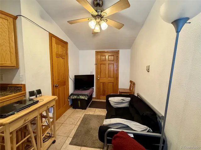a living room with a couch and a stove next to a window