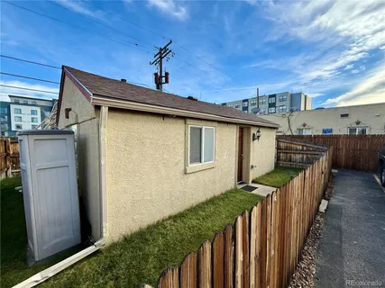 a view of a house with wooden fence