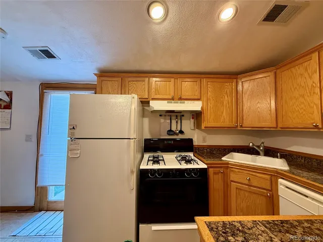 a kitchen with stainless steel appliances a refrigerator sink and cabinets