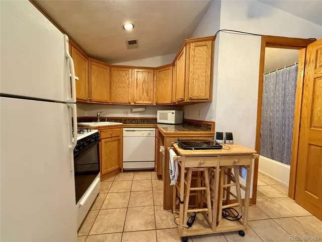a kitchen with a stove top oven sink and cabinets